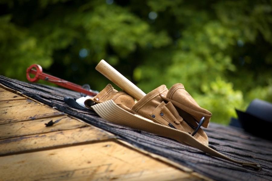 Roofing tools on a roof surface, highlighting common roofing mistakes.